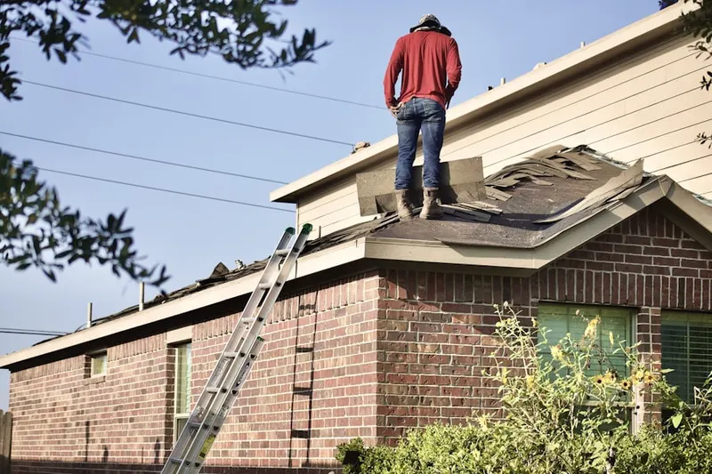 Professional roofer working on a residential roof in Notus